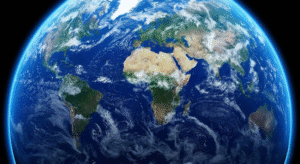 Vue de la Terre depuis l'espace montrant des continents tels que l'Afrique, l'Europe et l'Amérique du Sud, entourés d'océans bleus et de nuages blancs épars.